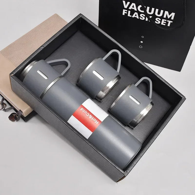 Gray vacuum flask set with two matching mugs in gift box, insulated hot cold drinkware kit