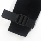 Adjustable black strap with buckle detail on a black fabric sleeve, closeup view