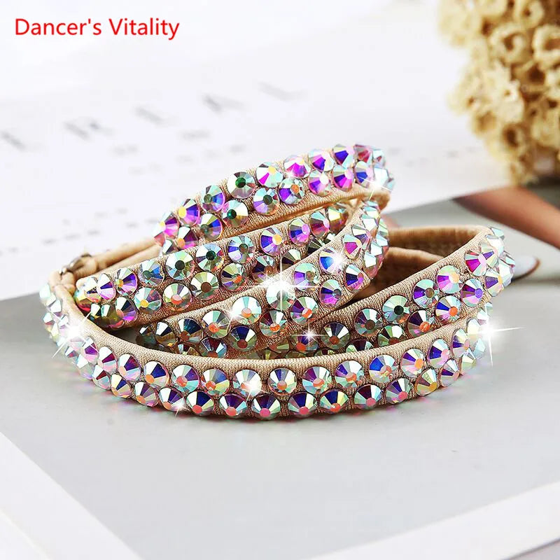 Sparkly rhinestone-studded headbands with iridescent gems on a neutral surface