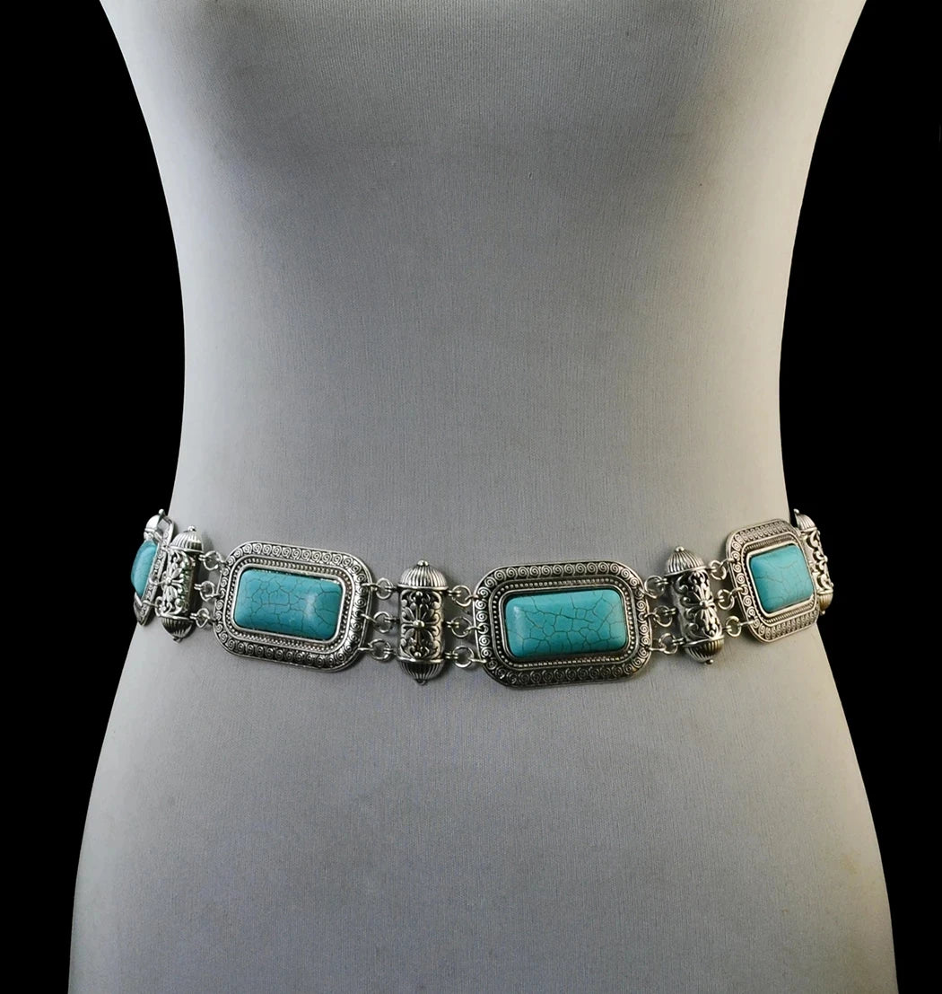 Silver waist belt with ornate turquoise stones on a mannequin, bohemian jewelry accessory