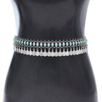 Boho silver coin waist belt with turquoise accents on mannequin, belly dance accessory