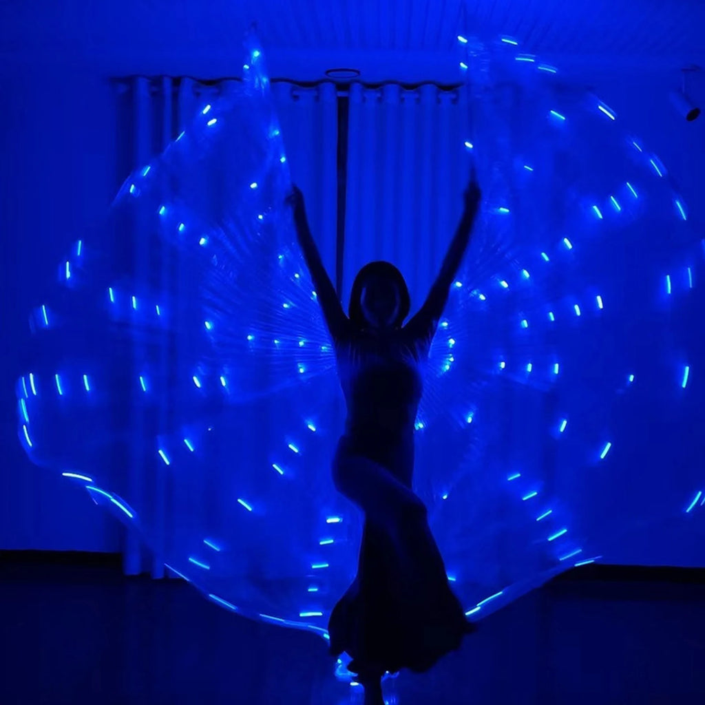 Dancer performing indoors with blue LED light up wings in a dark room.