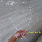 Hand holding white flexible rod, 1m to 1.2m length, on wood floor background.