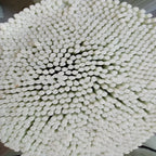 Close-up of bundled white drinking straws arranged in a circular pattern