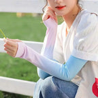 Woman outdoors wearing pastel gradient arm sleeves and white short-sleeve blouse