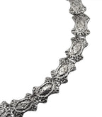 Textured silver necklace with ornate, linked oval segments on a white background