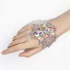 Hand wearing an ornate crystal rhinestone hand chain bracelet with iridescent gems