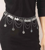 Silver coin chain belt with layered chains on a black dress, fashion accessory